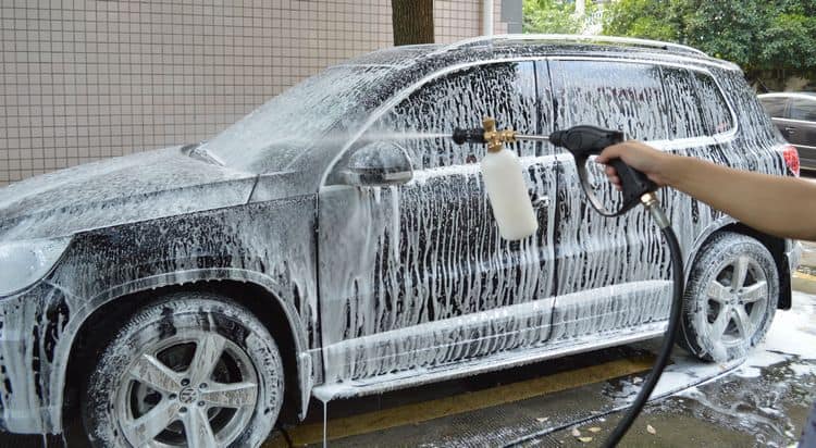 Car covered in foam during a pre-wash using a foam cannon