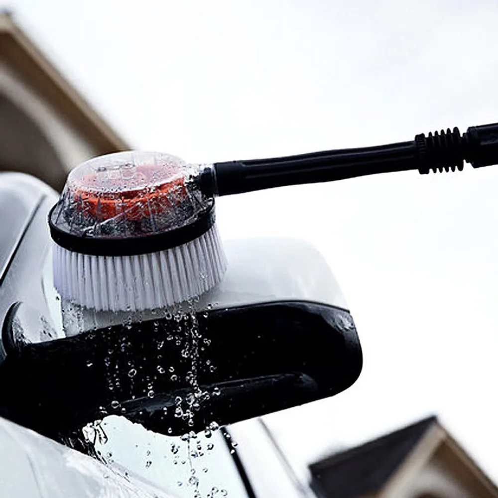 Rotating car washing brush cleaning a side mirror