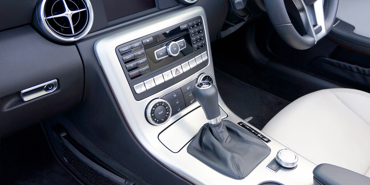 A spotless car interior showcasing a clean dashboard, center console, and door panels, highlighting the results of effective cleaning techniques.