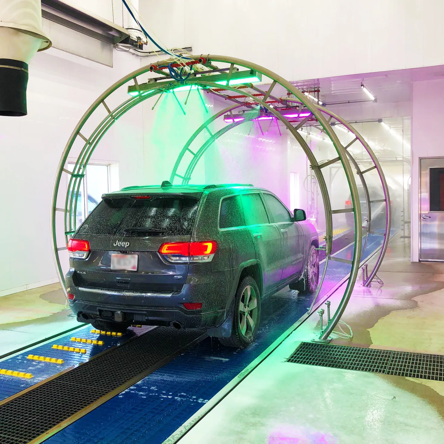 A car going through a drive-through car wash