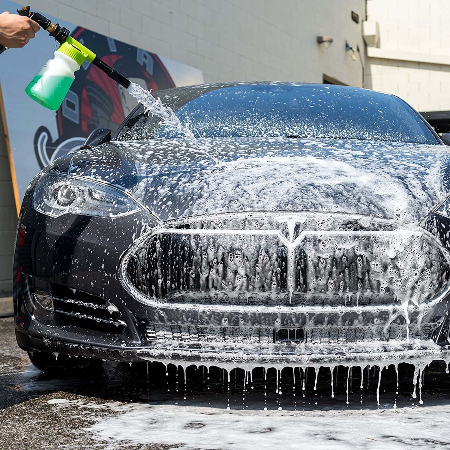 Using a foam cannon to apply car shampoo at a self-service car wash