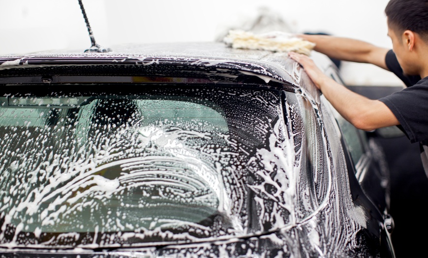 Car being washed with soap and sponge, highlighting the difference between car wash soap and dish soap