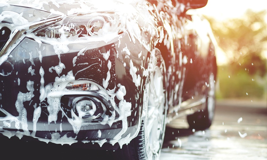 Car covered in soap during a DIY car wash